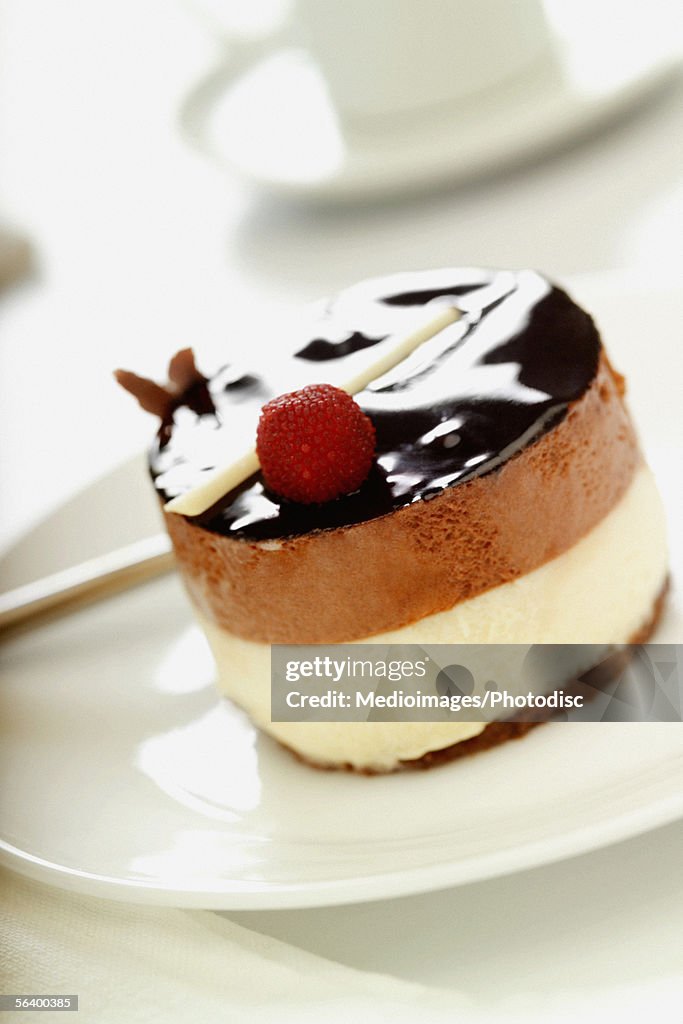 Ornate cheesecake on plate with coffee cup in background, close-up, selective focus