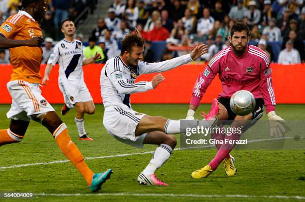 Los Angeles Galaxy midfielder David Beckham attempts a shot on goal against Houston Dynamo goalkeeper Tally Hall in the second half of the MLS...