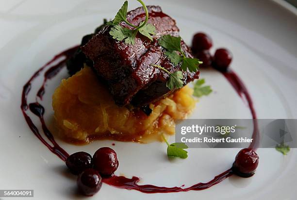 Pork Belly made with apple cider, green barley and lovage oil is one of the featured dinner menu items at Laurel Hardware.