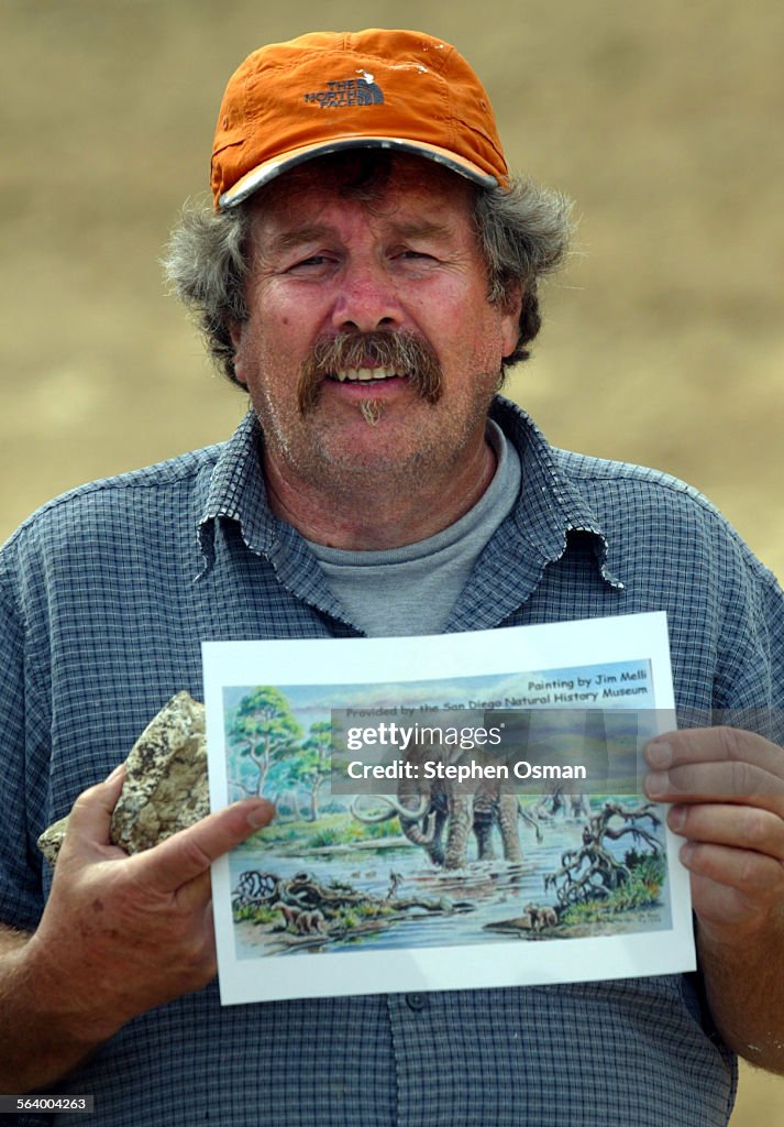 Moorpark, CA.04–07–2005: Palentologist Mark Roeder shows a photo of what the mammoth may have looke