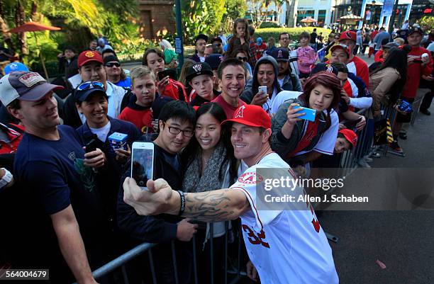 Angels newest signing, outfielder Josh Hamilton, takes a photo with fans following a press conference to introduce the 2010 American League MVP and...