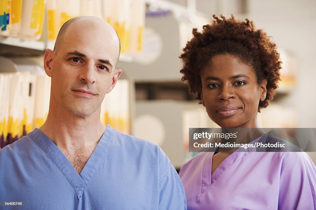 Two smiling healthcare workers in medical records room