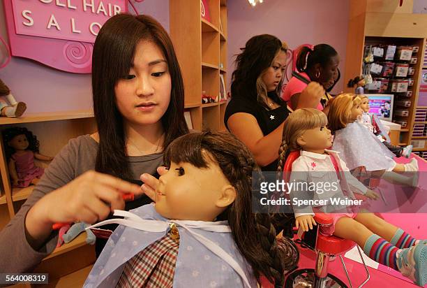 Summer Lee, left, is one of several 'hairdressers' who will give your American Girl doll a new hairstyle while you shop, Tuesday, April 18, 2006 at...