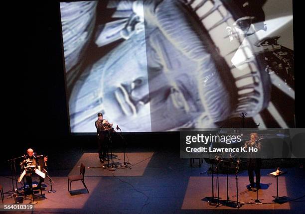 Joseph Petric, Guy Few, and Eric Vaillancourt in Murderous Little World, multimedia music theater work by Canadian composer Linda Bouchard based on...