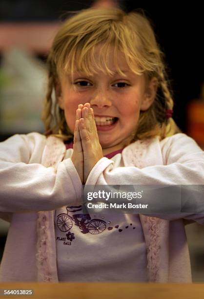 Samantha Brittingham warms up with some exercises before her handwriting lesson in Becke Prince's second grade classroom at Don Juan Avila...