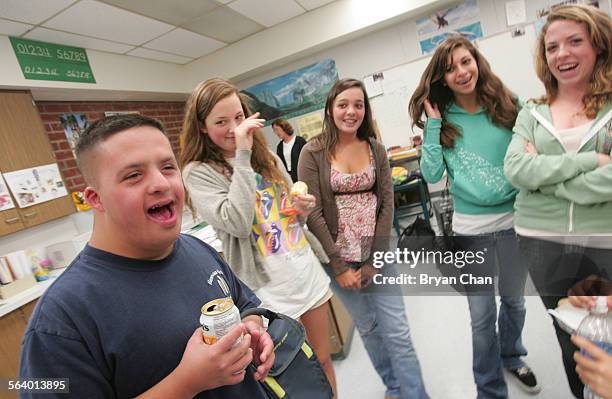 Special ed student Jacob Dominguez, left, shares a laugh with Nora Lewis, Taylor Nutten, Glenn Rich, and Hannah Geiser during a lunchtime meeting at...