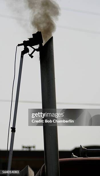 Smog Check device is inserted into the smoke stack of a diesel truck to measure emissions as California Air Resources Board enforcement team does...