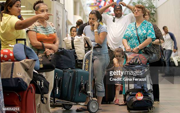 Rocio Salazar of Van Nuys waits in line with about 200 other passengers trying to rebook flights inside Terminal 1 at LAX after a power outage at the...