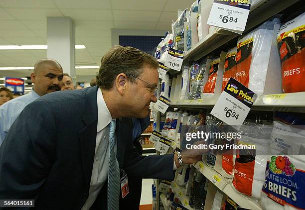 Lee Scott, President and CEO of Wal Mart Stores, Inc., looks examines mens underwear at the Wal Mart store in Panorama City. Scott visited the store...