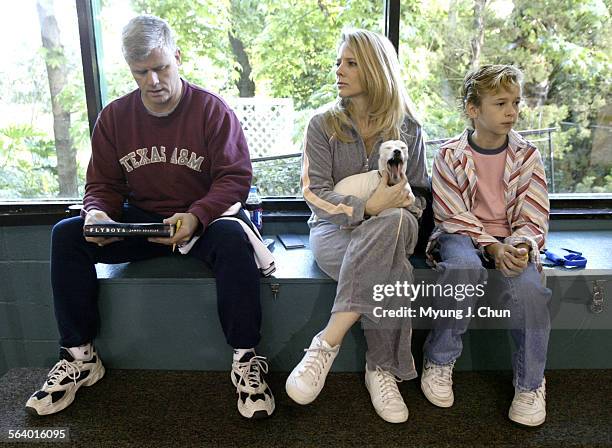 Mike Boyd , Debbie Boyd with their miniature Jack Russell terrier, Tippie and Cayden Boyd, 10 wait for Jenna Boyd to finish her ice skating lesson on...