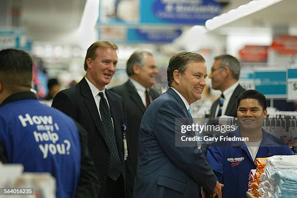 Lee Scott, President and CEO of Wal Mart Stores, Inc., greets employees and customers at the Wal Mart store in Panorama City. Scott visited the store...