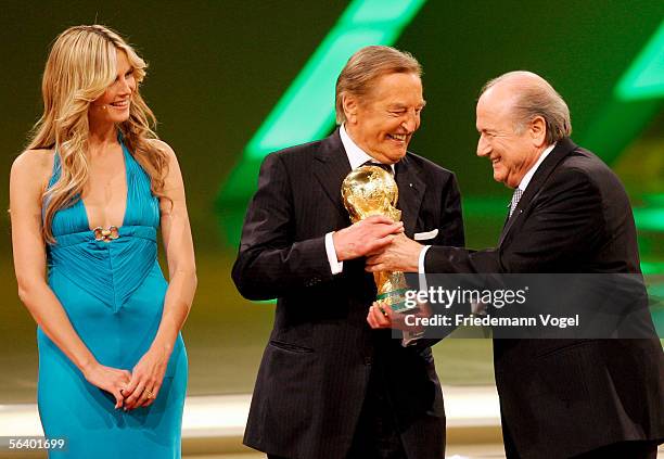 Heidi Klum, Gerhard Mayer-Vorfelder and Sepp Blatter participate in the World Cup draw show December 9, 2005 in Leipzig, Germany.