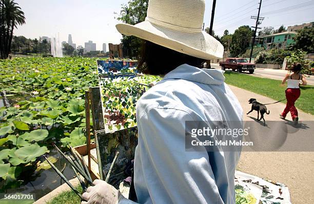 Sarah Arnold of Long Beach works on her oil painting of the lotus flowers thar are finally blooming in the Echo Park lake on August 7, 2006. They...