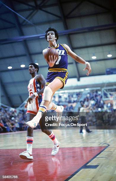 Guard "Pistol" Pete Maravich of the New Orleans Jazz jumps for a lay up during an NBA game against the New Jersey Nets circa 1977-79 at the Rutgers...