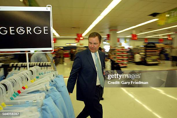 Lee Scott, President and CEO of Wal Mart Stores, Inc., looks at merchandise the Wal Mart store in Panorama City. Scott visited the store on 2/23/05 ...