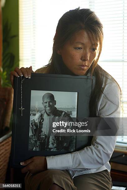 Karen Mendoza holds a portrait of her husband, U.S. Marine Corps Major Ray Mendoza, who was killed in Iraq in November of 2005. In addition to his...