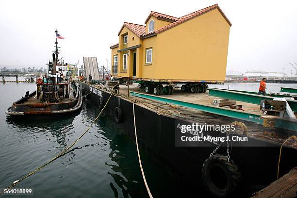 House sits on a barge at Terminal Island that will be used to transport that and, eventually, five others to the USC Wrigley Institute for...