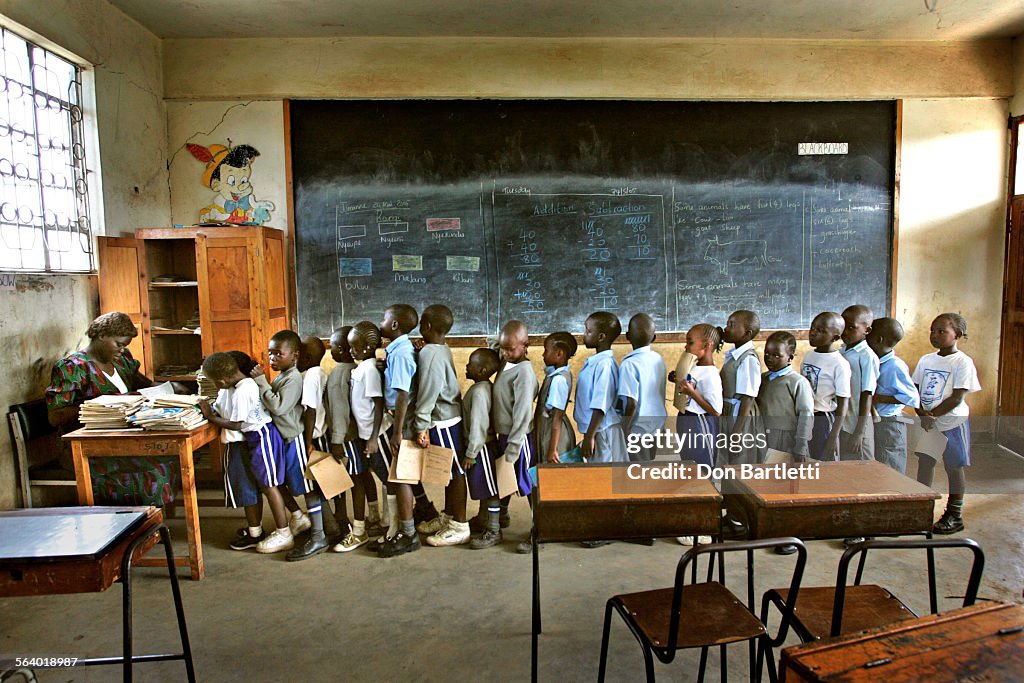 May 24, 2005. Kisumu, Kenya. Edwin Baraka and his 1st grade classmates form a tight line to collect