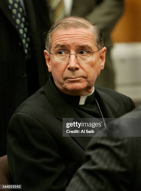 Cardinal Roger Mahoney turns to look to the back of the courtroom as victims of priest abuse were asked to stand. The Cardinal was sitting next to...