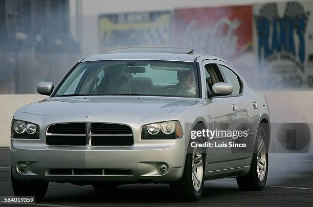 The new Dodge Charger R/T burns rubber at the Irwindale Speedway in Irwindale. Photo taken 6/16/05.