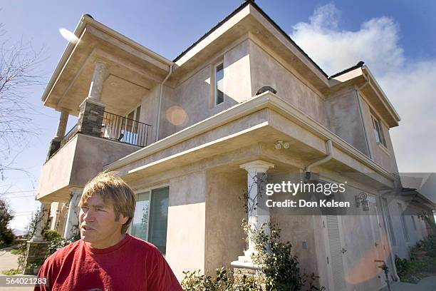  David Blunk, and his home built of steel talks of the wall of fire that leaped over his home Sunday during wind driven wildfire. PHOTOGRAPHED...
