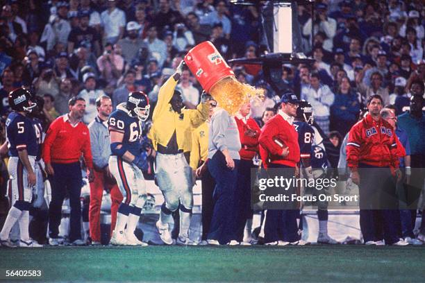 Linebacker Harry Carson of the New York Giants splashes a bucket of Gatorade over the head of Head coach Bill Parcells after defeating the Denver...