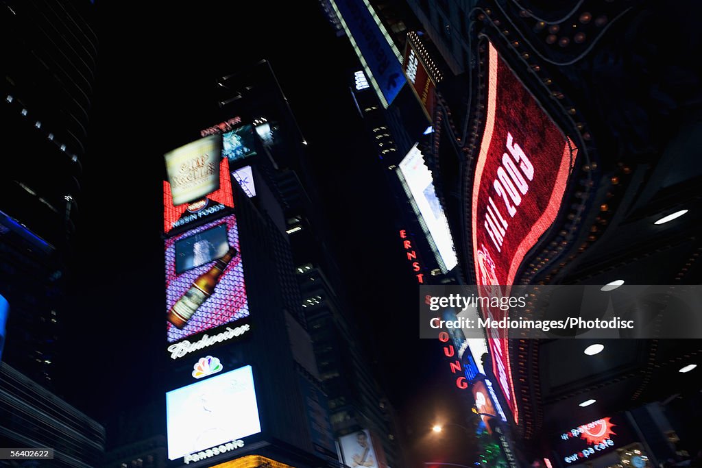 Low angle view of advertising in Times Square at night, New York City, NY, USA