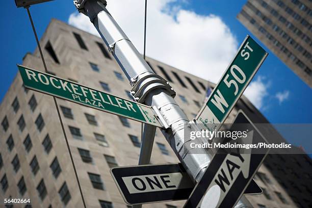 one way' sign and road signs of rockefeller plaza and west 50th street, new york city, ny, usa - centro rockefeller - fotografias e filmes do acervo