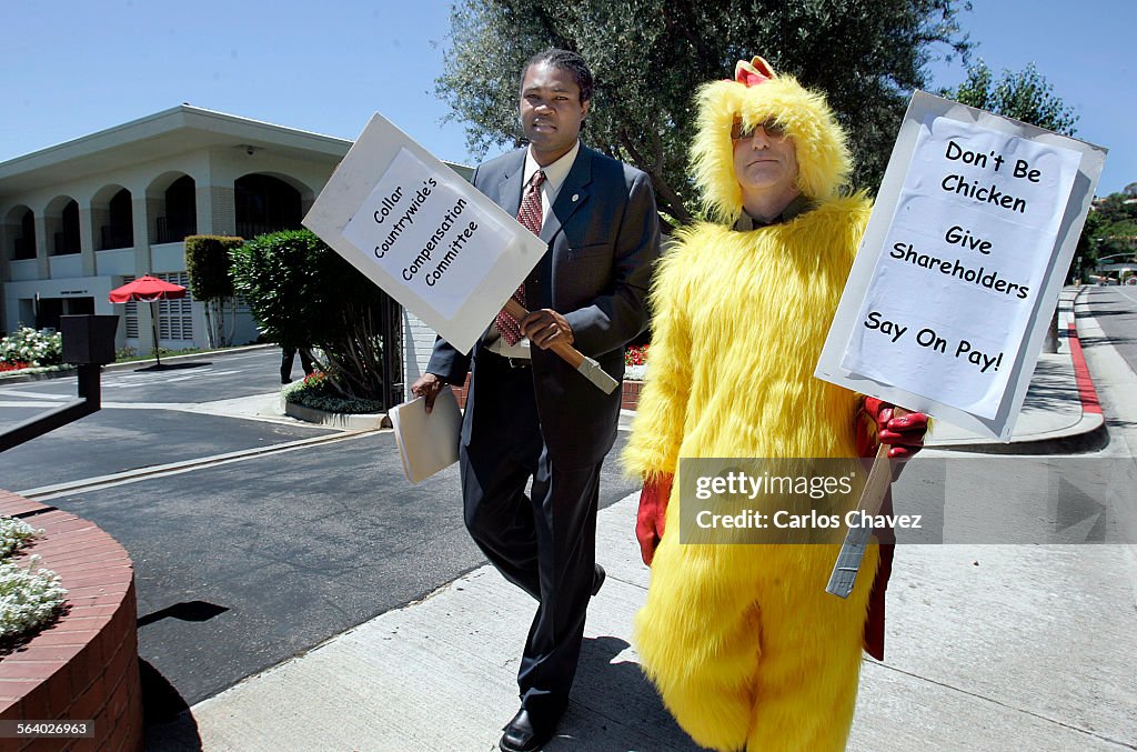 Yves Chery(cq) of LCERA and Scott Adams, AFSCME, in chicken suit protest against the pay of a Counr