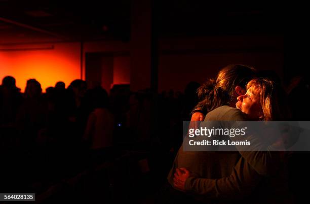 Mammoth,Ca.  Heather Berry, of Kernville, right, gets a hug while she holds back tears following a memorial service held on Friday night at Mammoth...