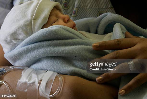 Marisela Brittingham holds her newborn son, Justin Brittingham Jr., after giving birth at the Naval Medical Center in San Diego. Her husband Justin...