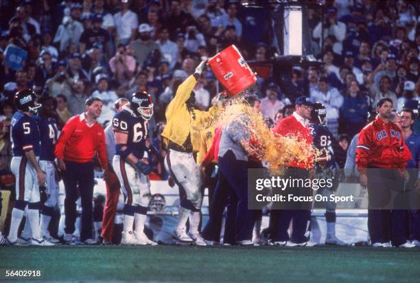 Linebacker Harry Carson of the New York Giants splashes a bucket of Gatorade over the head of Head coach Bill Parcells after defeating the Denver...