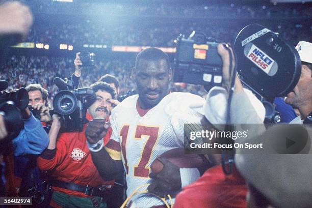 Doug Williams of the Washington Redskins walks past the media after winning the Super Bowl XXII against the Denver Broncos at Jack Murphy Stadium on...