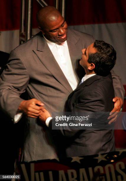 Earvin "Magic" Johnson greets Los Angeles Mayor Elect Antonio Villaraigosa as he takes the stage during his election night party at Los Angeles...
