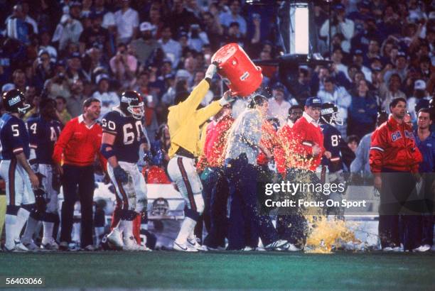 Linebacker Harry Carson of the New York Giants splashes a bucket of Gatorade over the head of Head coach Bill Parcells after defeating the Denver...