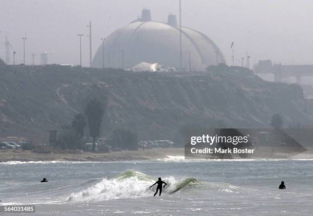 Surfers on the south end of Trestles enjoy the waves, with the San Onofre Nuclear Power Plant in the background. The famous surf beach in southern...