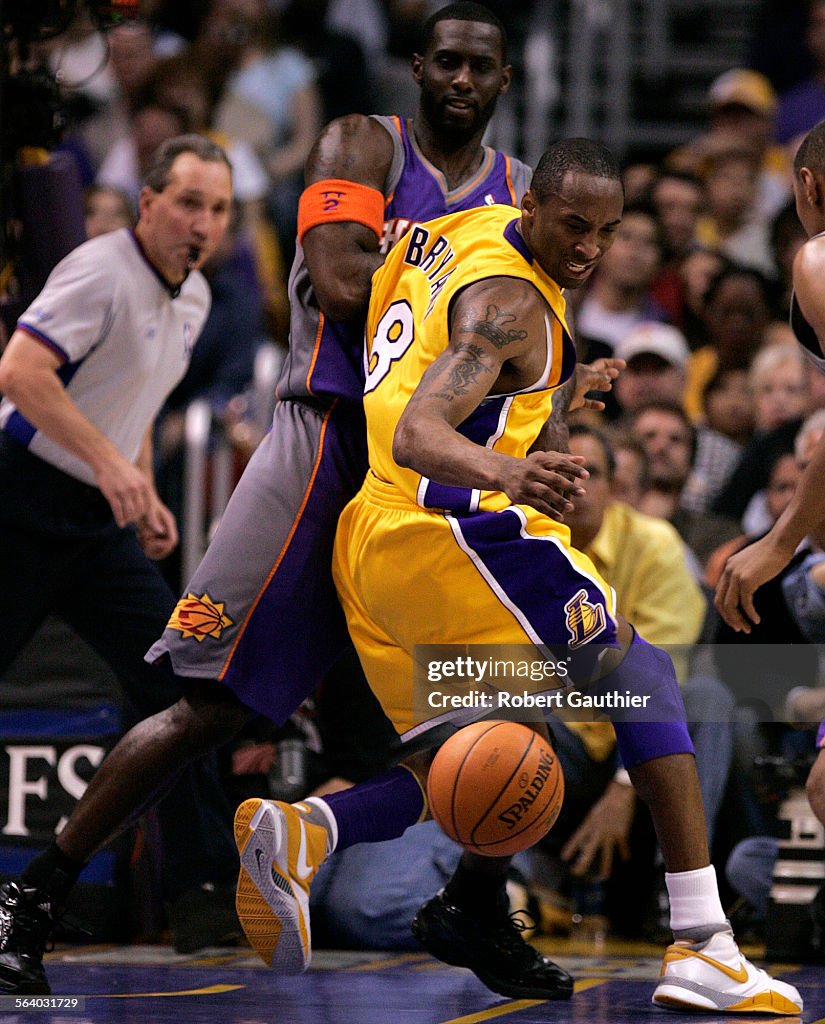 Laker Kobe Bryant has trouble driving in against the Phoenix Suns Tim Thomas in Game 6 of the NBA W