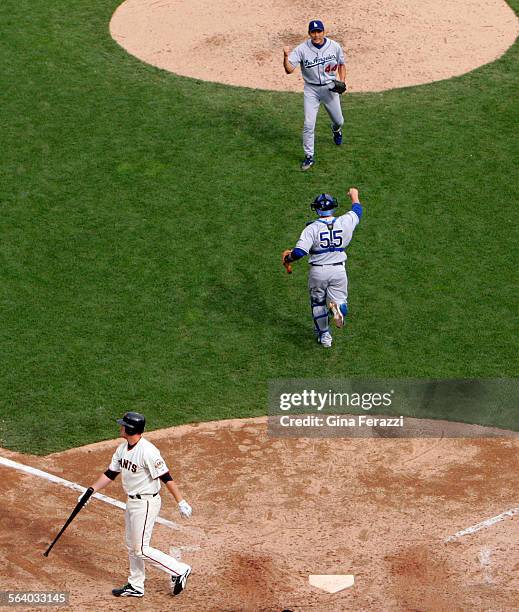 Dodgers pitcher Takashi Saito runs to catcher Russell Martin as the Dodgers clinched the wildcard with a 42 win over the San Francisco Giants AT&T...