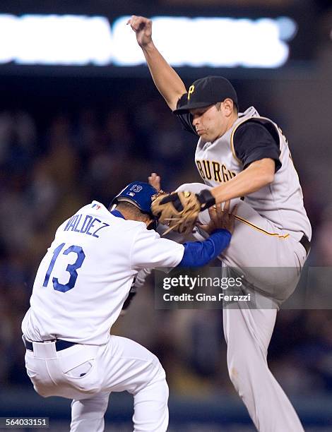 Pittsburgh Pirates second baseman Freddy Sanchez kicks Dodgers Wilson Valdez while chasing an overthrown on a wild pitch in the bottom of the ninth...