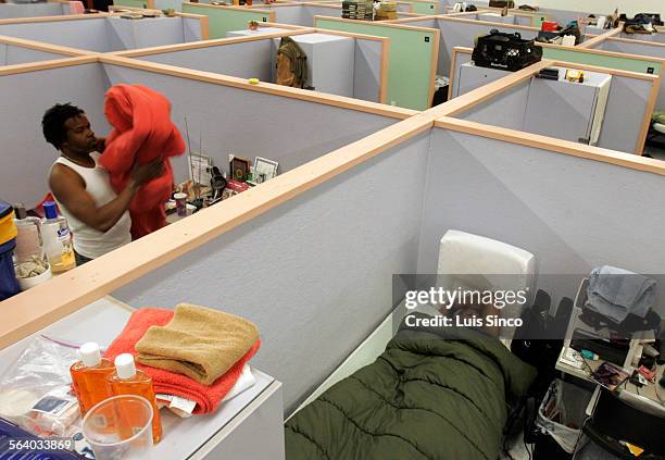 Eric Monte, right, sleeps as the lights go on at 5:00 a.m. At the Salvation Army's homeless shelter in Bell. A high school dropout from Chicago,...