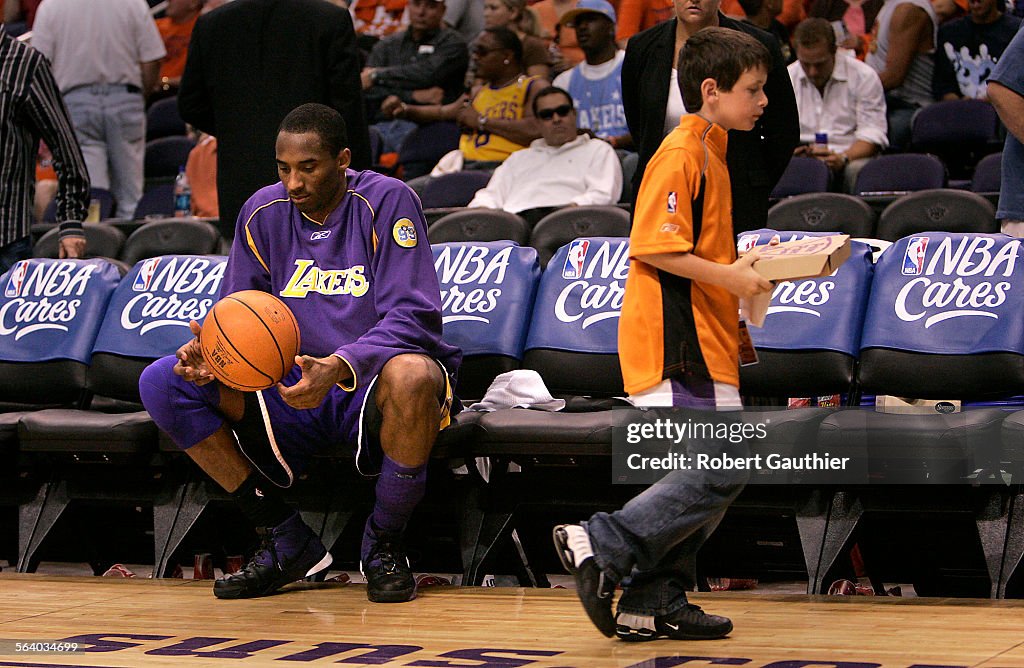 Alone with his thoughts at halftime, Kobe Bryant of the Los Angeles Lakers waits for the start of t