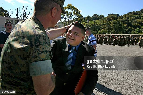 Camp Pendleton, Ca.  Carlos GomezPerez is congratulated by U.S. Marine Sgt. Major William Skiles after GomezPerez was awarded the Silver Star for...
