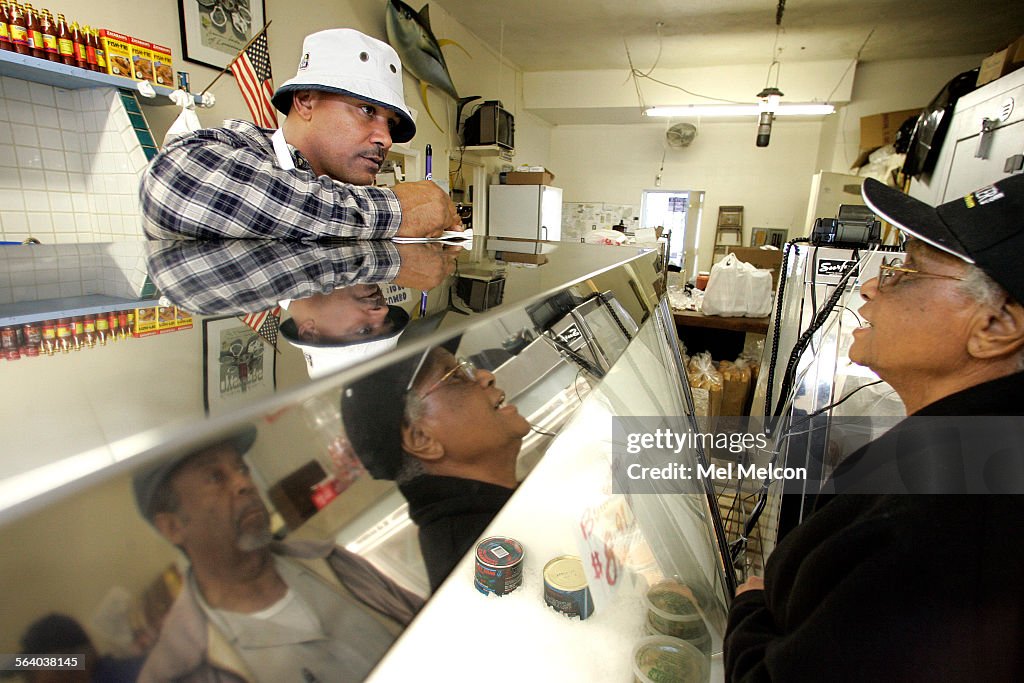 Anthony Cosme, owner of the New Orleans Fish Market on Vernon Ave. in South Los Angeles, takes a cu