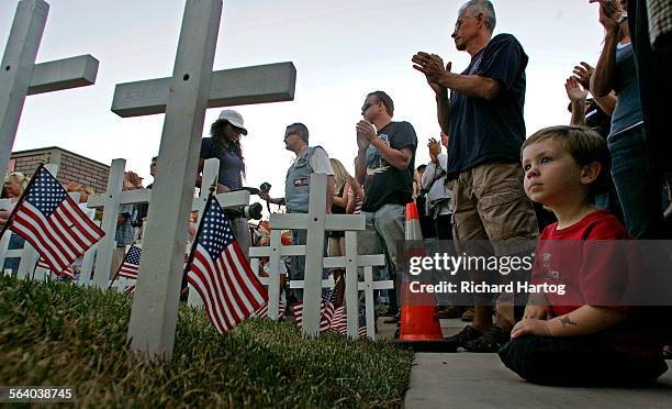 Threeyearold Gavin Wilson, right, of San Clemente is wideeyed as he watches a ceremony at the end of The Ride to commemorate the 911 anniversary...