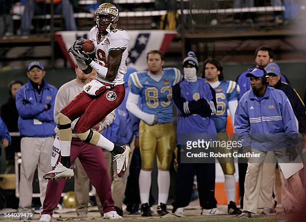 Head coach Karl Dorrell, right, can only watch as Florida State receiver Greg Carr catches a pass for a big gain in the fourth quarter of the Emerald...