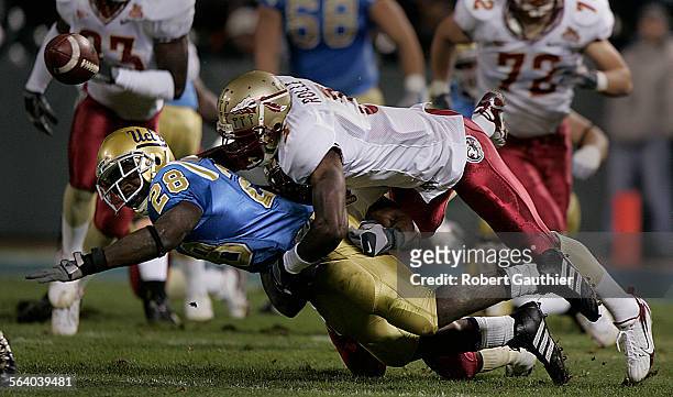 Running back Chris Markey fumbles the ball after a hard tackle by Florida State defender Myron Rolle in the first half of the Emerald Bowl at AT&T...