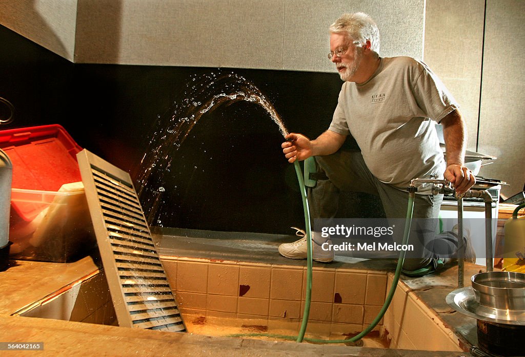 Foley artist John Roesch, demonstrates spraying water against an old ...