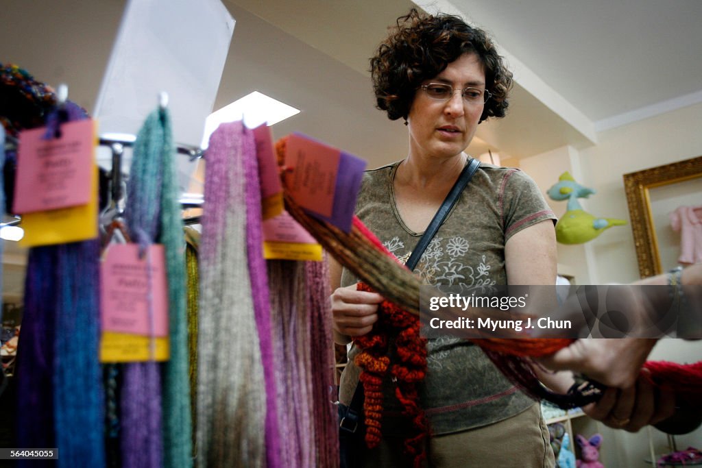 Customer Lynn Latta (cq) is shown hand painted cultivated silk at Compatto: A Yarn Salon in Santa M