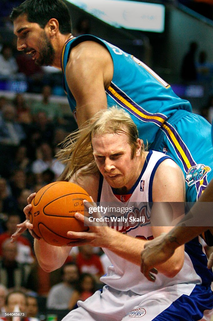 Clippers Chris Kaman is fouled by Hornets Peja Stojakovic in the second quater at the Staples Cente