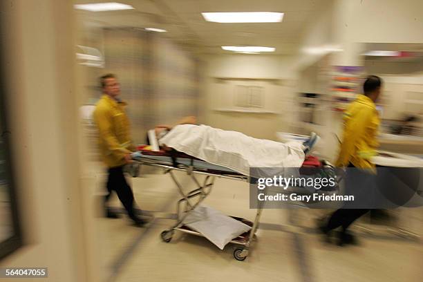 Patient is wheeled into the emergency room at the Downey Regional Medical Center emergency room on 10/6/2006.Downey and other nearby hospitals are...